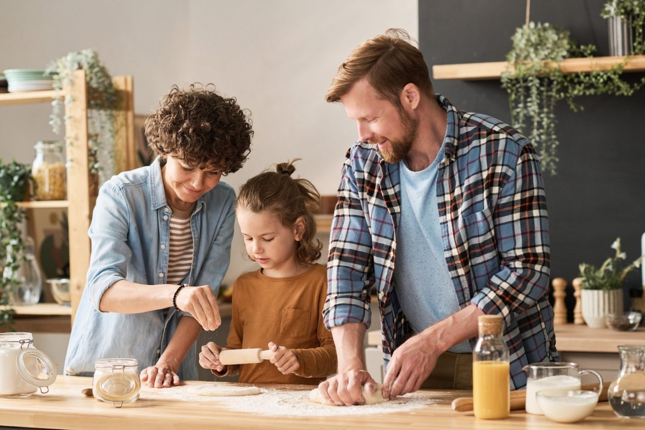 parents-teaching-child-to-bake-pie.jpg